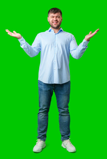 istock A man playfully posing with a quirky expression against a bright green background 2185680836