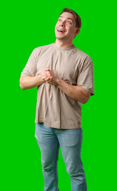 istock A cheerful man with a friendly smile poses against a bright green background 2185681018