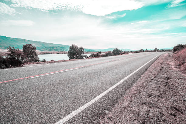 Picturesque landscape scene and sunrise above road