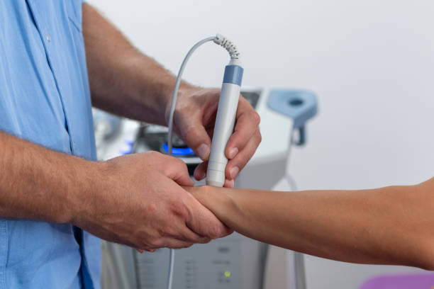 istock Physical therapist performs laser therapy on a patients wrist, focusing on reducing pain, inflammation, and promoting faster recovery 2185687427