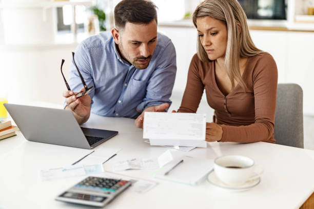 istock Displeased couple paying bills over Internet at home. 2185687907
