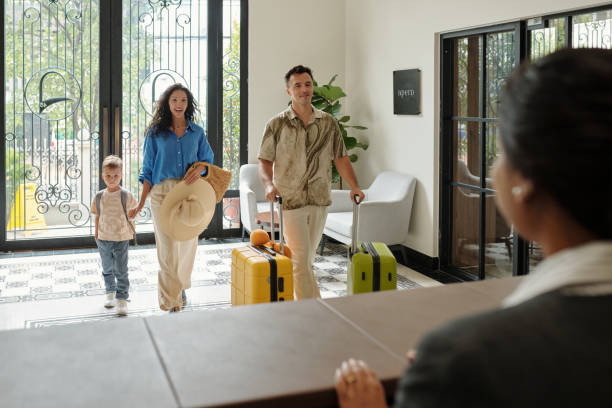 Family Checking into Hotel Lobby with Luggage