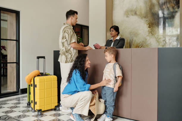 istock Checking In at Hotel Reception Desk with Family Members 2185690452