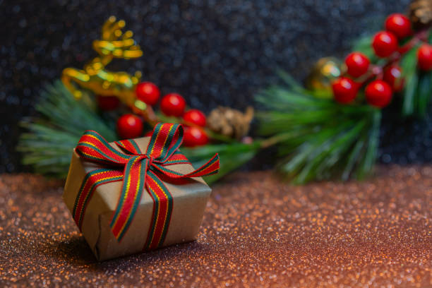 istock Gift boxes and pine cones and branches on the background of bokeh. 2185691001