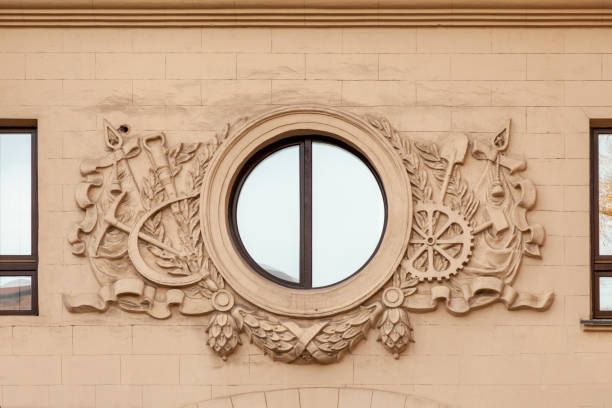 istock Fragment of a building wall with a round window and a bas-relief with the Soviet Union 2185691933