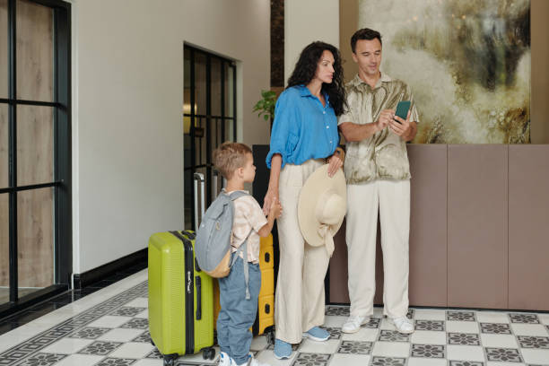 istock Family Checking into Elegant Hotel with Luggage and Smiling 2185692072
