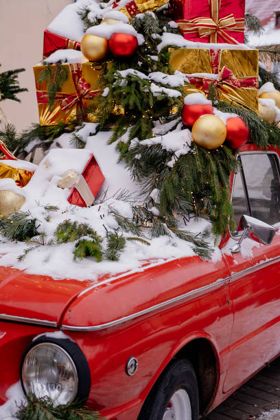 istock Red car with green christmas tree and presents. Interest decor 2185692364