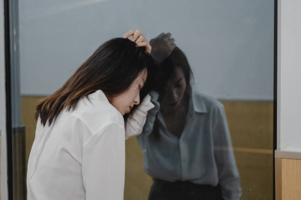 istock Asian female office worker collapses on her way home from work 2185694748