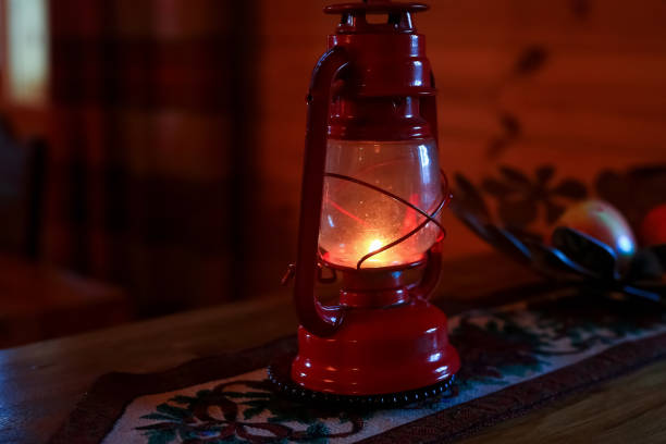 Christmas twilight, retro red lamp standing on the embroidered napkin as a Christmas decoration in the house