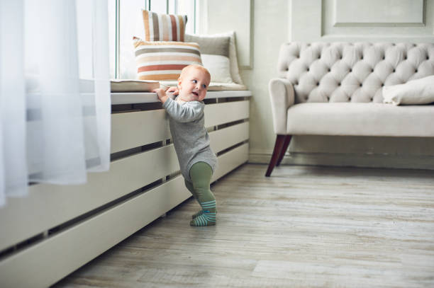istock Baby exploring a modern living room with stylish decor during daytime 2185694786