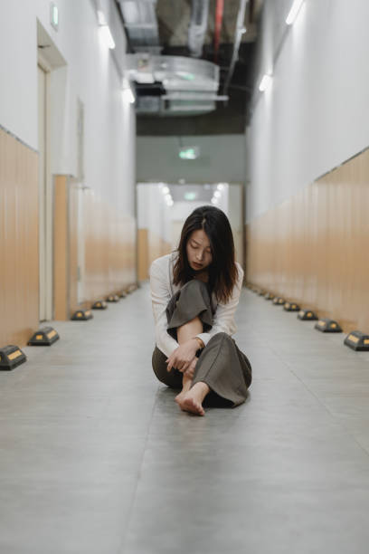 istock Asian white-collar women sitting on the floor, desperate workers 2185694792