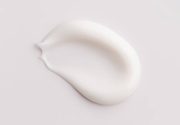 istock creamy smear of white cosmetic texture on gray background 2185696496