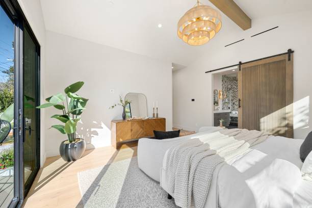 istock Modern bedroom with natural light and barn door. 2185698577