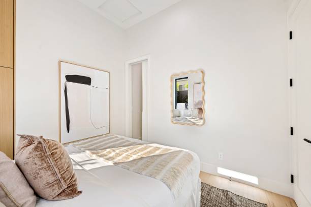 istock Modern minimalist bedroom with abstract art and cozy bedding. 2185699157