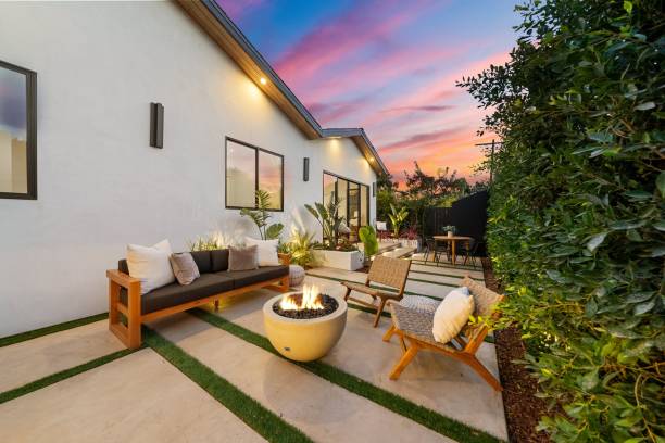 istock Modern backyard patio with cozy seating and fire pit at sunset. 2185699180