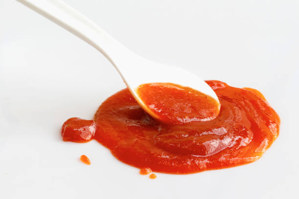 istock white spoon on chili sauce 2185700371