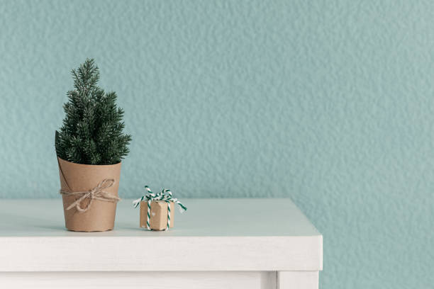 istock Christmas background with a small artificial Christmas tree and a gift box 2185700712