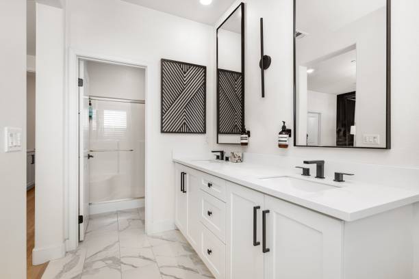 istock Modern bathroom with dual sinks and black fixtures. 2185701771
