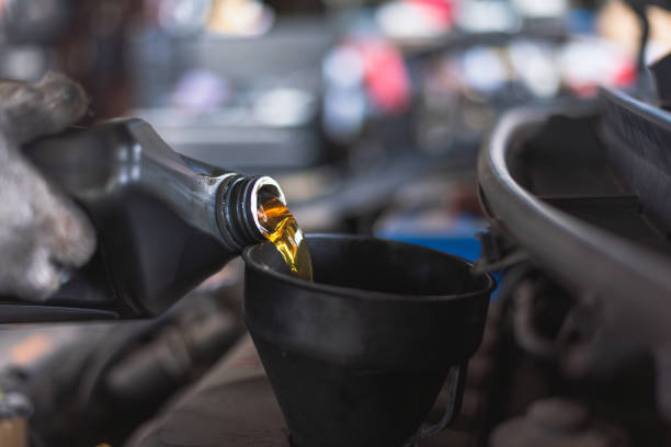 istock Pouring Motor Oil into Car Engine Funnel 2185702508