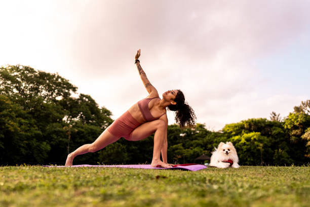 istock Young woman stretching in a public park 2185702576