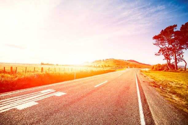 Picturesque landscape scene and sunrise above road