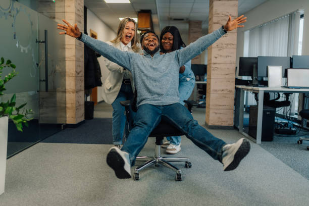 istock Business team having fun riding office chair in modern office 2185702606