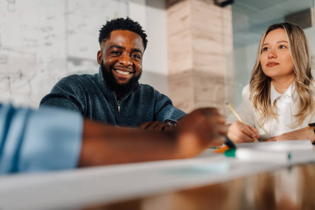 istock Smiling businessman leading creative meeting with diverse team 2185702682