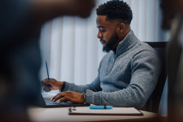 istock Focused businessman working on laptop in modern office 2185702784