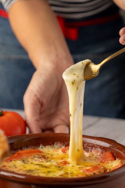 istock Cheesy pizza dip with fresh tomatoes being served 2185702904
