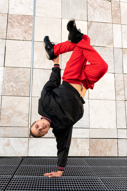 istock A young man in red pants performs a breakdance pose on a metal grate 2185703201