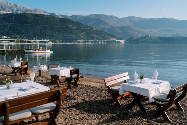 istock Laid tables with chairs stand on the seashore overlooking the mountains 2185704580
