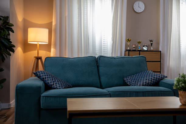 istock A Cozy Living Room Featuring a Blue Sofa Set Against a Backdrop of Warm Lighting 2185704621
