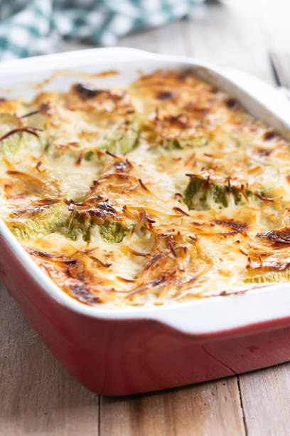 istock Casserole with cheese and gratin zucchini on wooden table 2185706405
