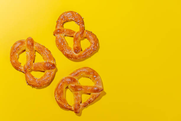 istock Pretzels scattered across a bright yellow background 2185708824