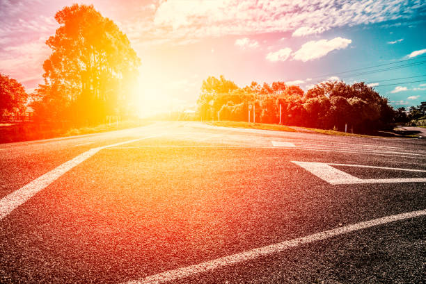 Picturesque landscape scene and sunrise above road