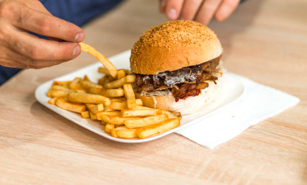 istock Delicious Cheeseburger with Fries on a White Plate 2185710361