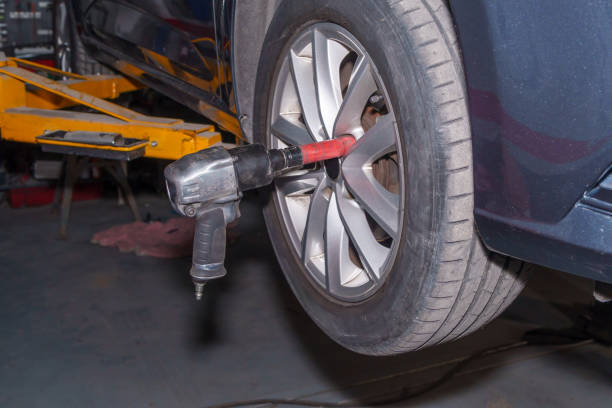 istock Pneumatic tool connected to car wheel in garage 2185710446