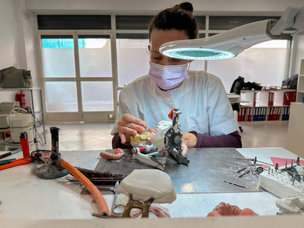 istock Woman dental technician working in dental laboratory 2185711920