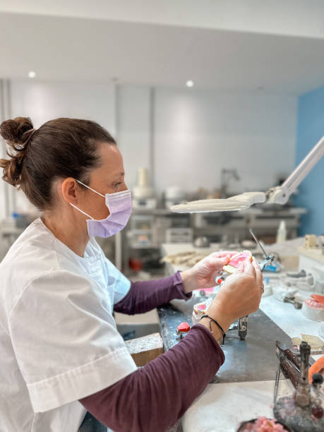 istock Woman dental technician working in dental laboratory 2185712492