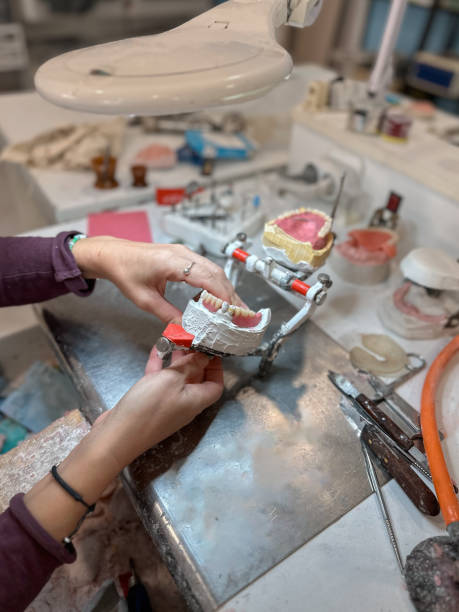 istock Woman dental technician working in dental laboratory 2185712570