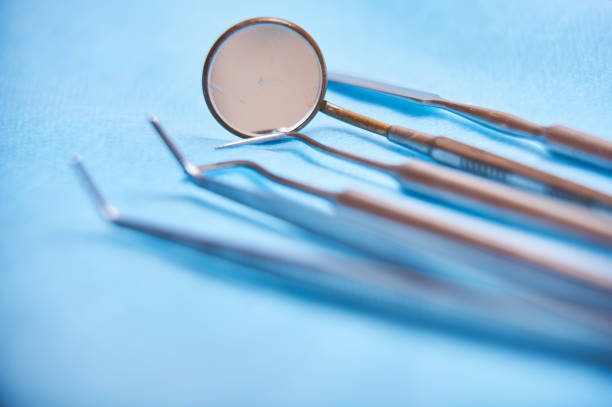 istock Dental tools on blue background highlighting instruments for oral hygiene and examination 2185715606