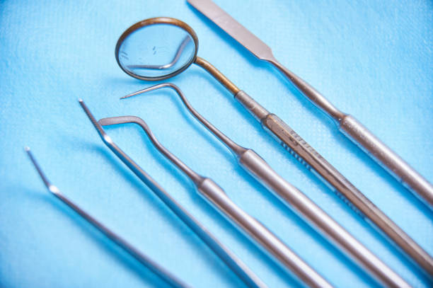 istock Dental tools arranged on a blue surface for professional dental examination and treatment preparation 2185715612