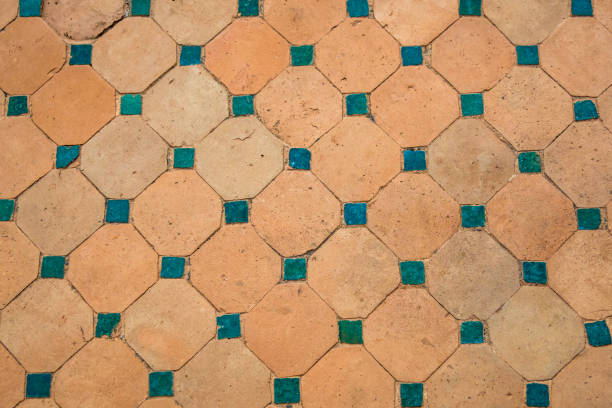 istock Rustic terracotta tiles adorned with teal ceramic square accents, weathered texture, design element for interiors, marketing, backgrounds or creative projects emphasizing vintage Mediterranean charm. 2185716305