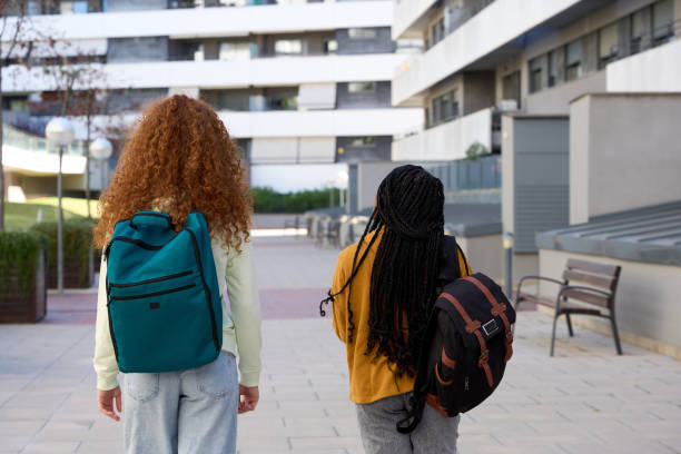 istock Two female students walking away from university campus 2185716313