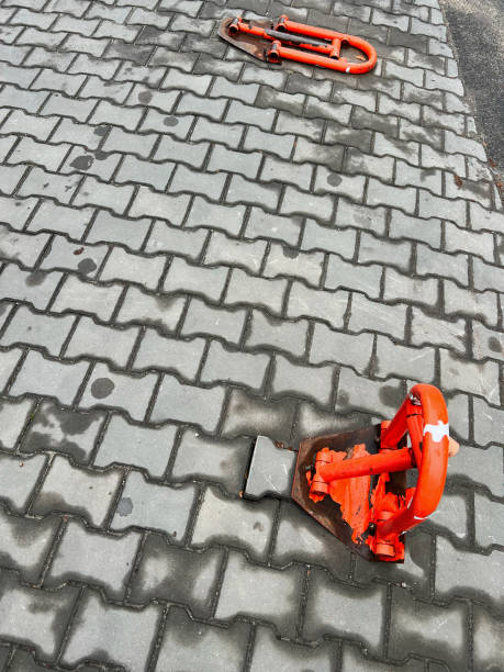 istock Red metal parking barrier on a paved urban sidewalk 2185717924
