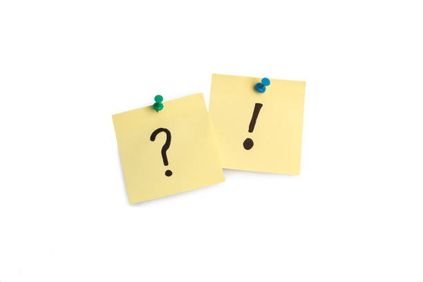 istock Exclamation mark and question mark drawn on a yellow sticky paper hanging on a white background 2185721183