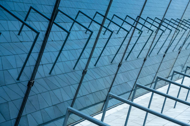istock Geometric reflections in the windows of vacant bicycle racks. 2185721325