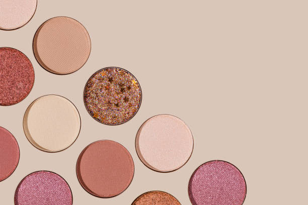 istock Cosmetics texture pattern, Warm vivid colored eye shadow makeup palette, round eye powder swatches. Female cosmetic and beauty products, aesthetic minimal beauty photo, colorful eyeshade, top view 2185721370