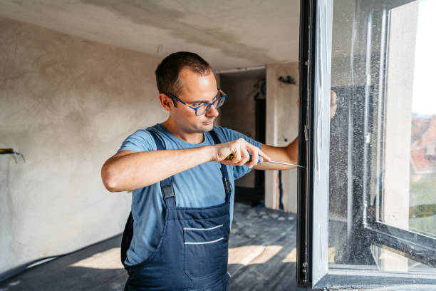 istock Repairman Screwing The Windows In An Empty Apartment Under Renovation 2185722805
