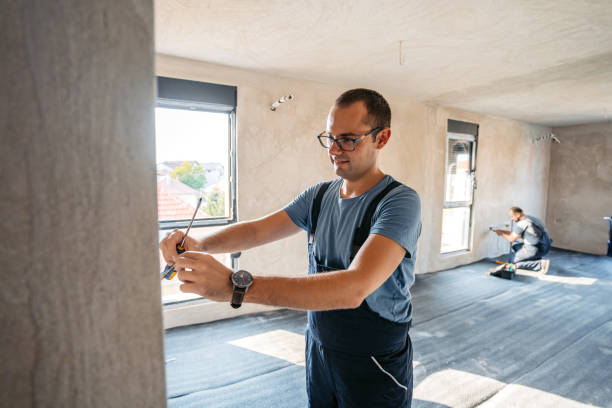 istock Electrician Working With Electric Cables In An Empty Apartment Under Renovation 2185723196